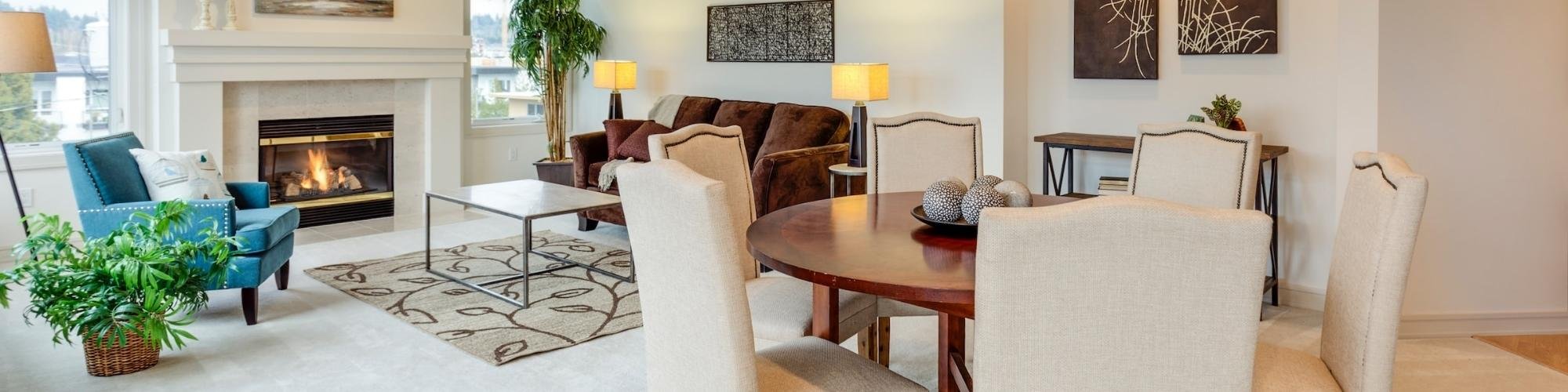 white sofa and armchairs in front of a fireplace with an brown area rug from The Wholesale Flooring Company in Myrtle Beach, SC